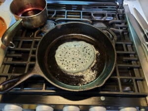 Accidental sourdough pancakes with blueberries cooking Accidental sourdough pancakes with blueberries cooking