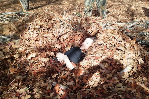 tx woman in debris pile Texas woman in leaf pile survival shelter